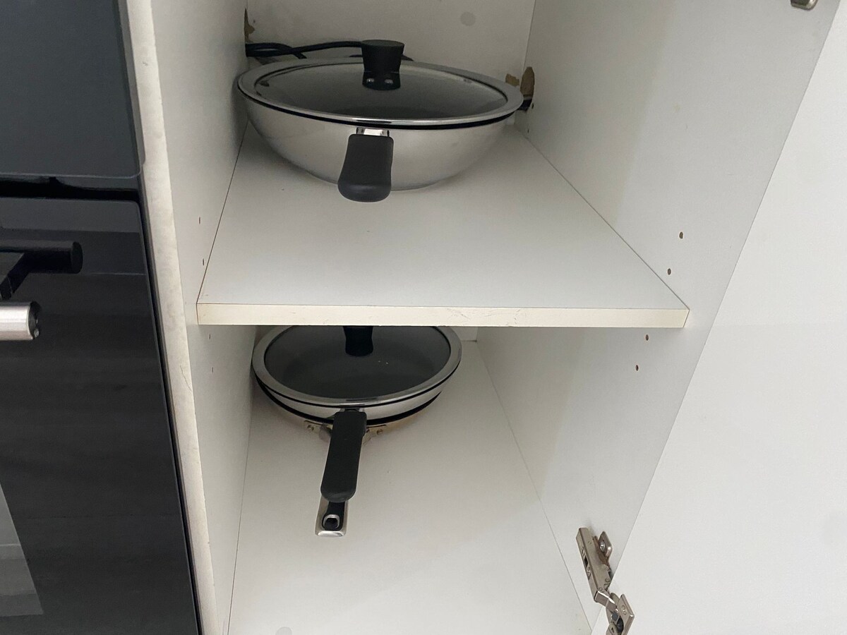 Kitchen cupboard with cookware at Luxe Nest, 33 Maya Avenue