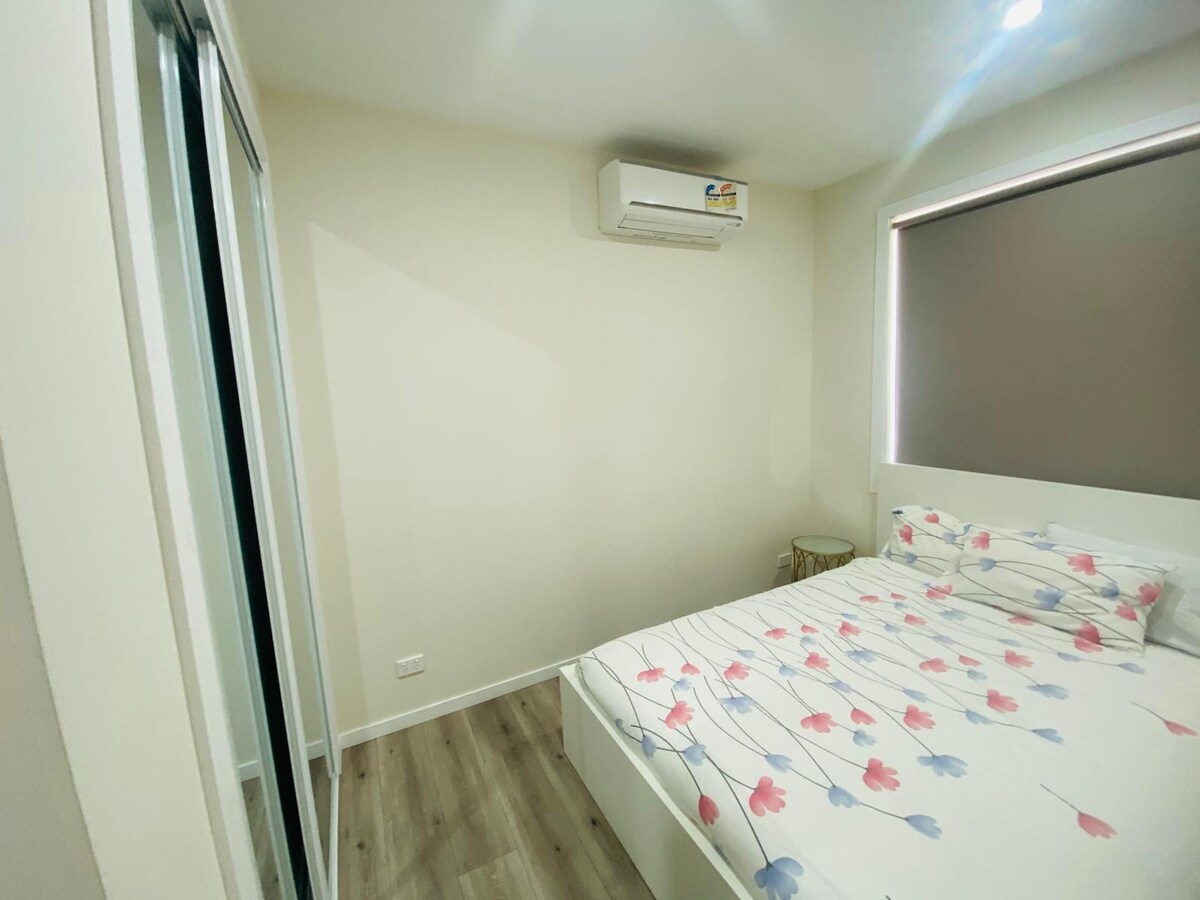 Bedroom with white patterned quilt at Luxe Nest, 33 Maya Avenue