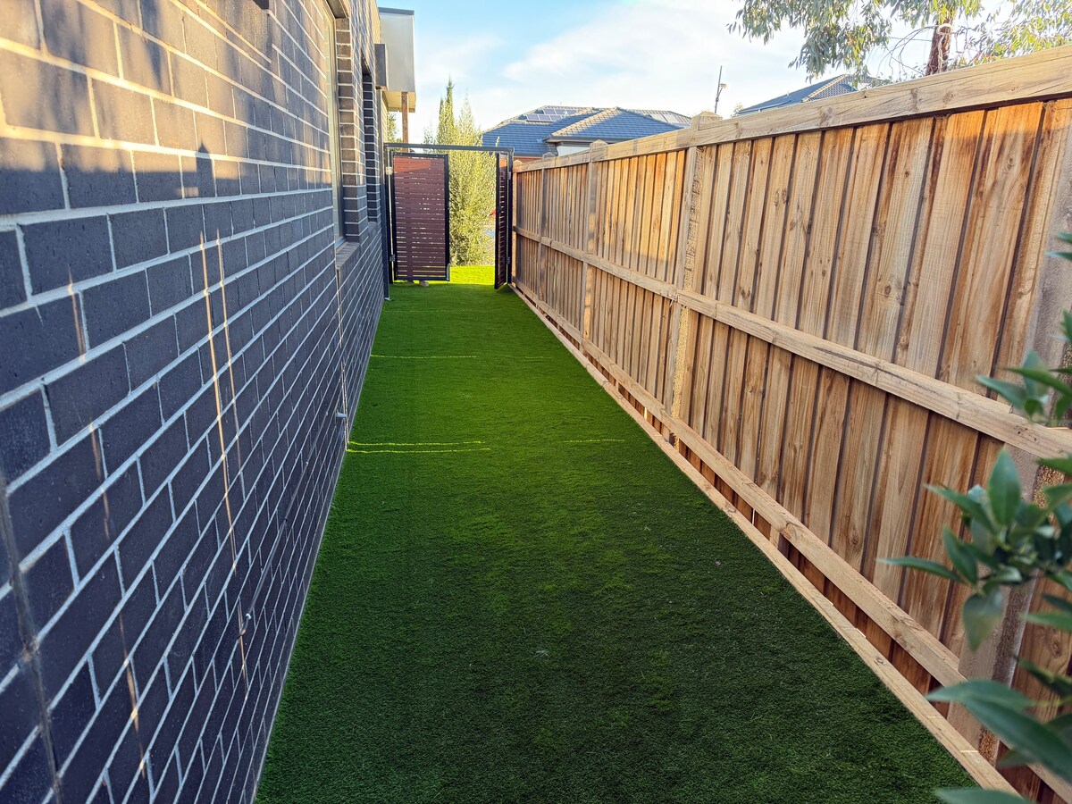Private side yard with artificial turf at Luxe Nest, 33 Maya Avenue