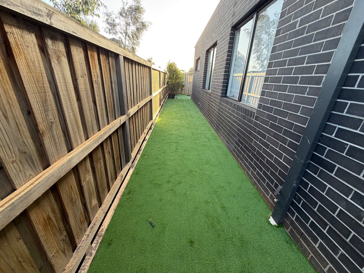 Side garden path beside the home at Luxe Nest, 33 Maya Avenue