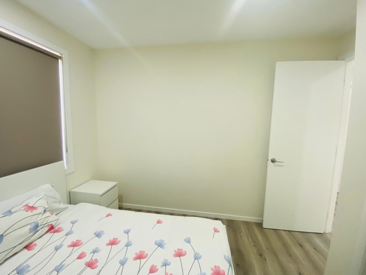 Bedroom with white patterned quilt at Luxe Nest, 33 Maya Avenue