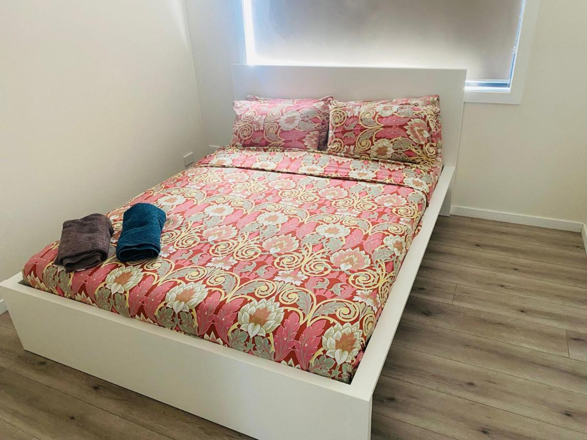 A prepared queen bedroom with fresh towels at Luxe Nest